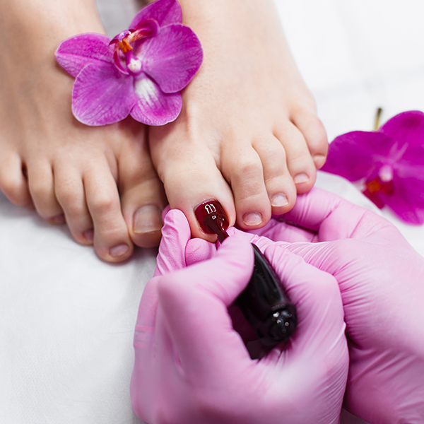 nail artist painting toe nails